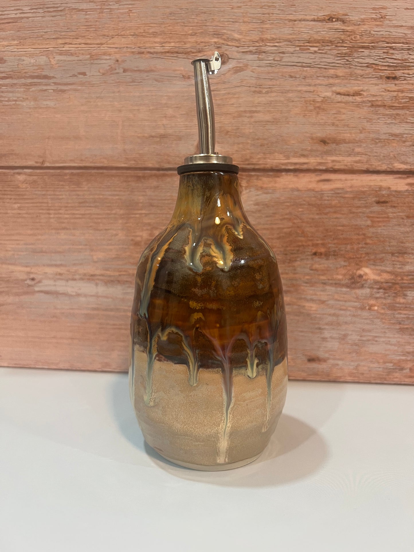Oil Pourer - creams & browns with drips of blue. Thumb imprint for easy pouring