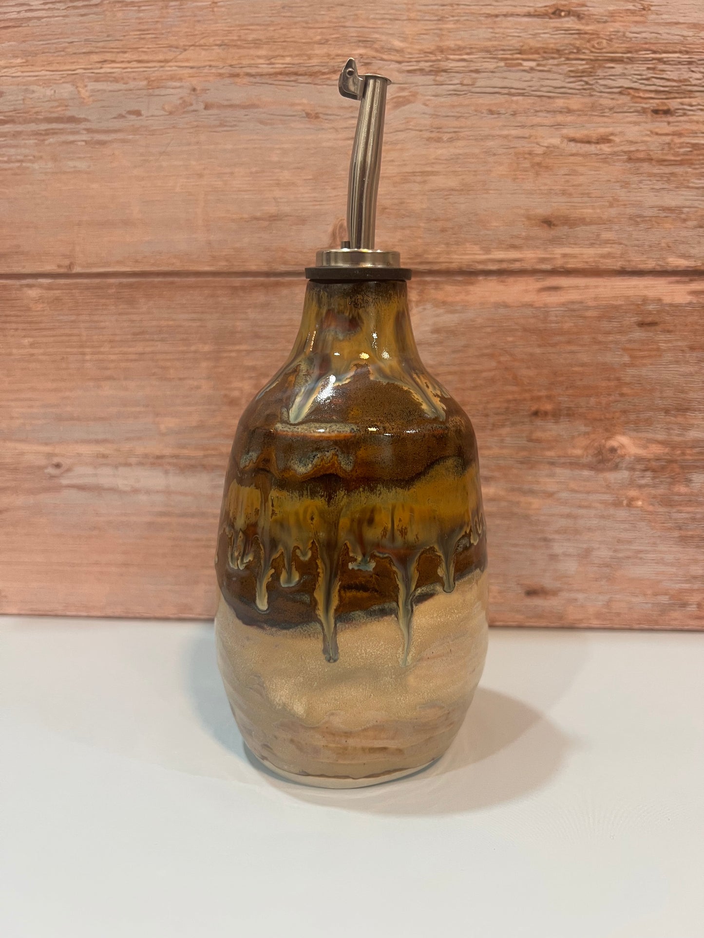 Oil Pourer -  creams & browns with drips of blue. Thumb imprint for easy pouring